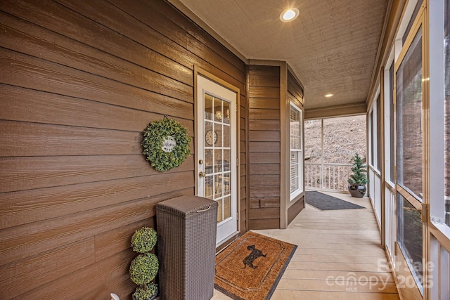 unfurnished sunroom with wood ceiling