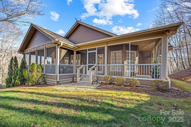 view of front of property with a front lawn and a sunroom