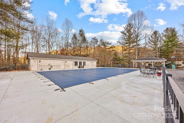 view of pool with a patio area and a gazebo