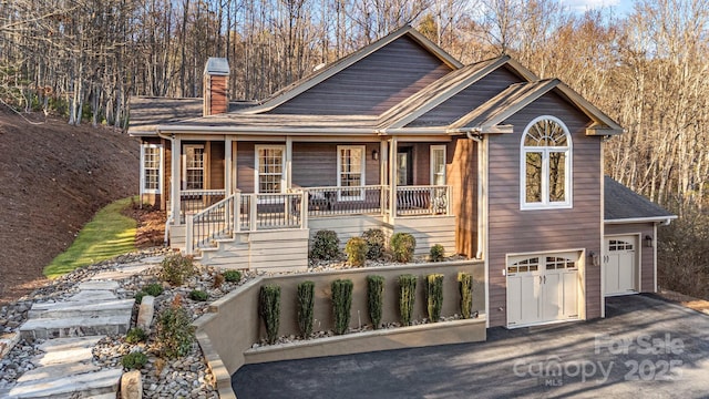 view of front of house with a garage and a porch