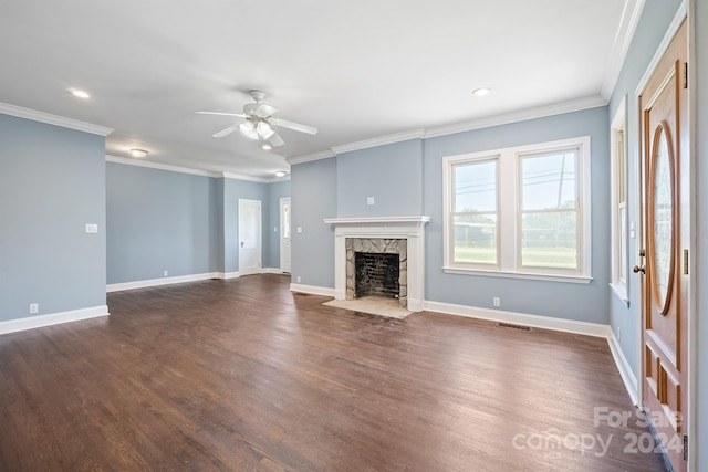 unfurnished living room featuring dark wood-type flooring, ceiling fan, crown molding, and a fireplace