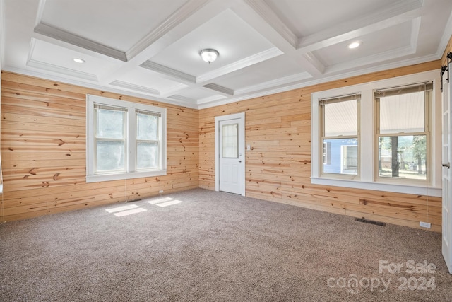 unfurnished bedroom featuring multiple windows, wood walls, and coffered ceiling