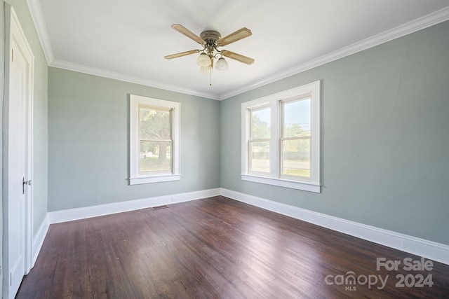 spare room with dark hardwood / wood-style flooring, crown molding, ceiling fan, and a wealth of natural light