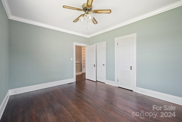 unfurnished bedroom featuring crown molding, dark hardwood / wood-style floors, and ceiling fan