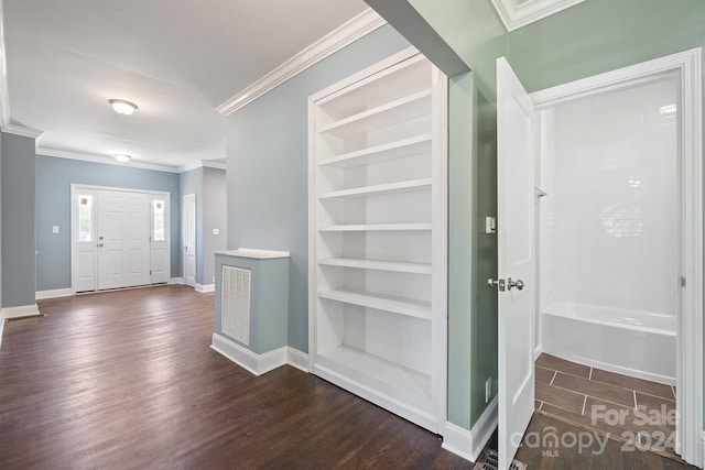 interior space featuring ornamental molding, dark wood-type flooring, and built in features