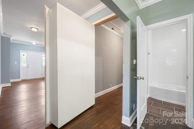 corridor featuring dark wood-type flooring and crown molding