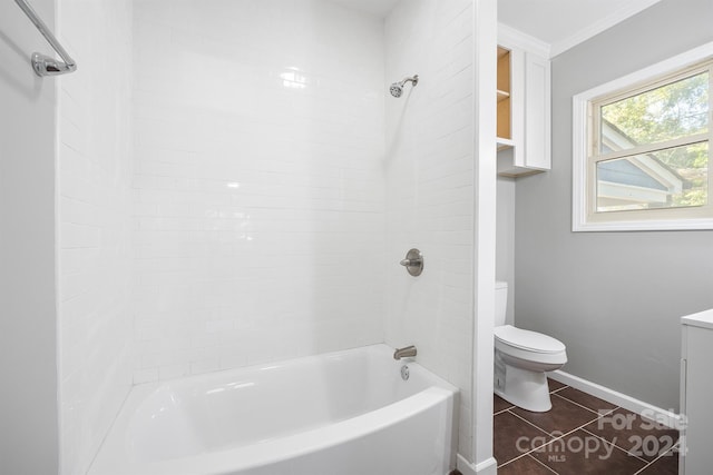 full bathroom with tiled shower / bath, toilet, vanity, crown molding, and tile patterned flooring