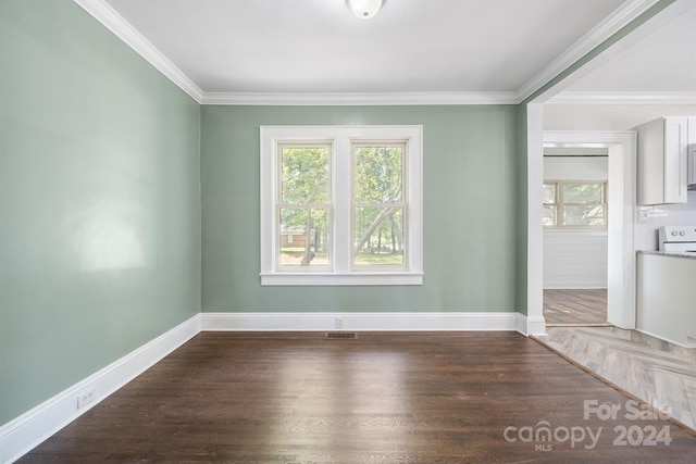 unfurnished room with ornamental molding and hardwood / wood-style floors