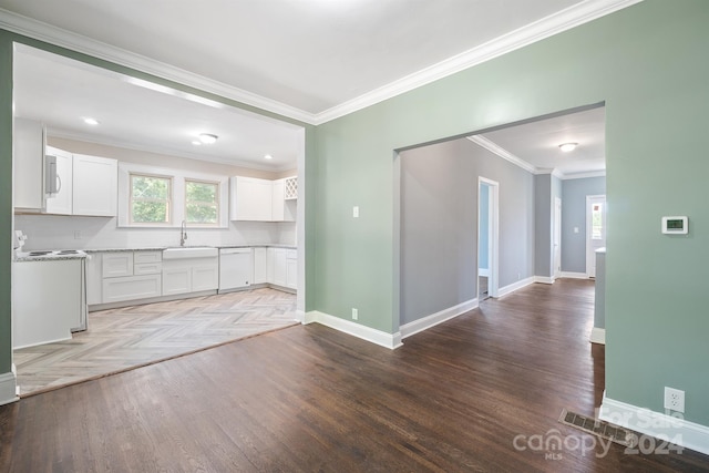 kitchen with crown molding, white cabinetry, sink, and white appliances