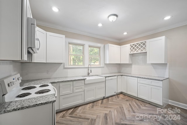 kitchen featuring white cabinets, light stone countertops, sink, and white appliances