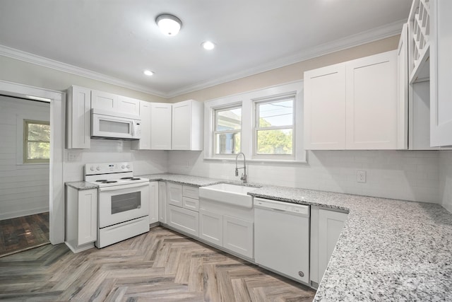 kitchen featuring white cabinets, light stone countertops, sink, light parquet floors, and white appliances