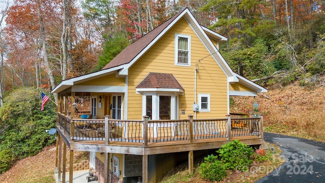 rear view of house featuring a wooden deck