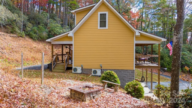 view of home's exterior with covered porch and ac unit