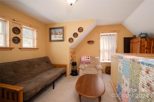 interior space with lofted ceiling and light carpet