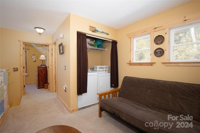 sitting room with light colored carpet and independent washer and dryer