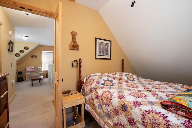 bedroom with light colored carpet and lofted ceiling