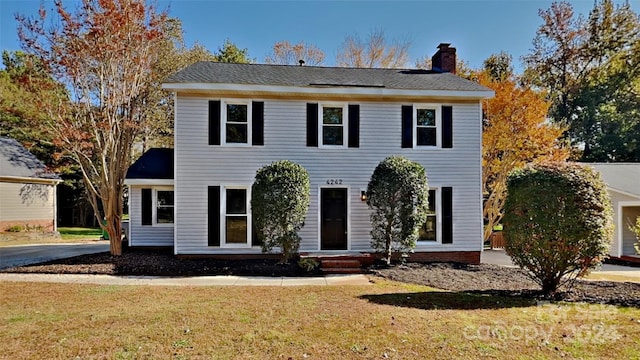 colonial inspired home with a front yard