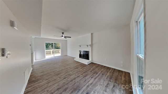 unfurnished living room featuring hardwood / wood-style floors, a fireplace, and ceiling fan