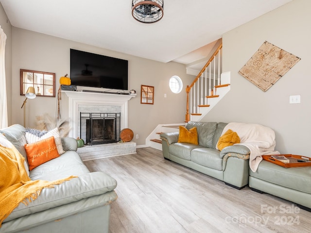 living room with a fireplace and light hardwood / wood-style flooring