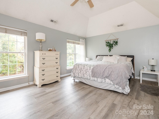 bedroom featuring ceiling fan, light hardwood / wood-style flooring, and vaulted ceiling