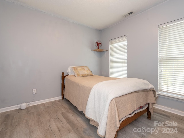 bedroom with wood-type flooring