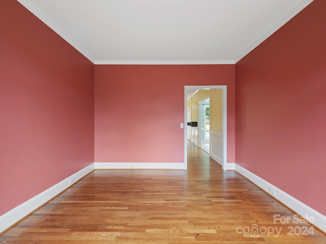 unfurnished room with crown molding and light hardwood / wood-style flooring