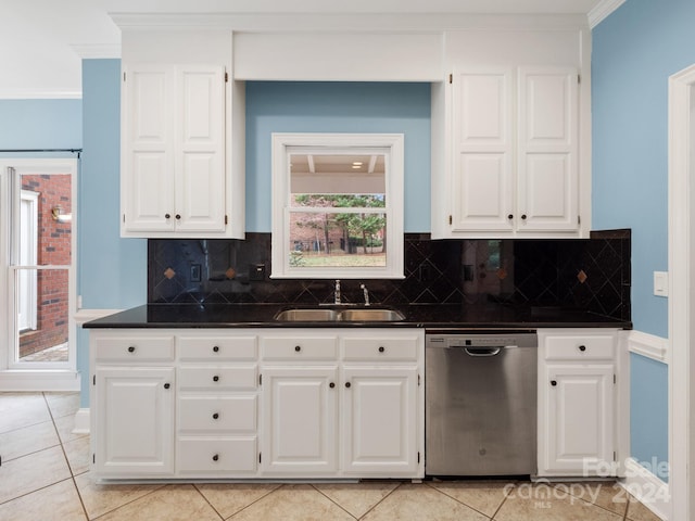 kitchen featuring white cabinetry, dishwasher, light tile patterned floors, and sink