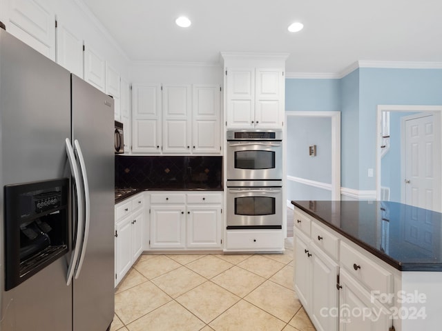 kitchen with white cabinets, appliances with stainless steel finishes, and crown molding