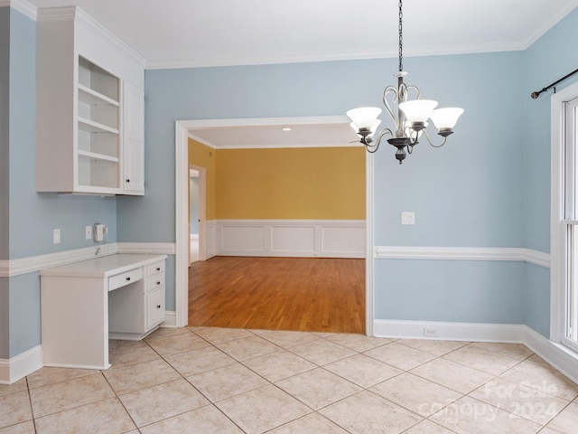 kitchen featuring built in shelves, white cabinetry, a chandelier, pendant lighting, and light wood-type flooring