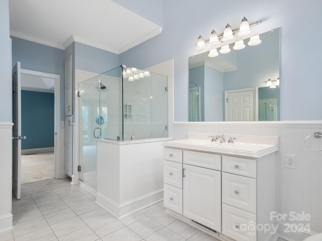 bathroom with tile patterned floors, vanity, crown molding, and walk in shower