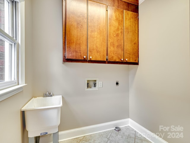 clothes washing area with cabinets, washer hookup, electric dryer hookup, sink, and light tile patterned floors