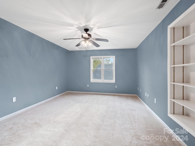 empty room with ceiling fan and carpet floors