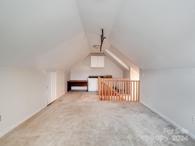 bonus room with light carpet and lofted ceiling