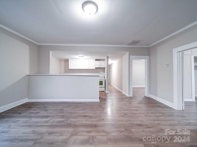 unfurnished living room featuring crown molding and light hardwood / wood-style flooring