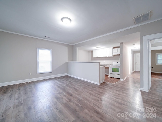 unfurnished living room with ornamental molding and light hardwood / wood-style flooring