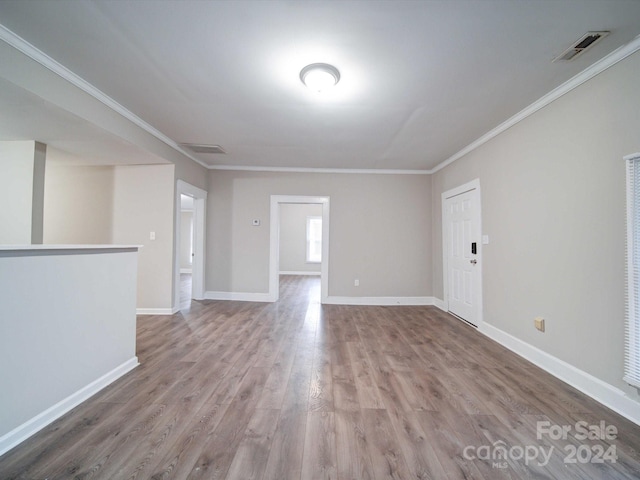 spare room with wood-type flooring and ornamental molding