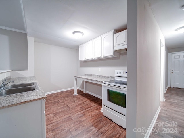 kitchen featuring white electric range oven, white cabinetry, light hardwood / wood-style flooring, and sink