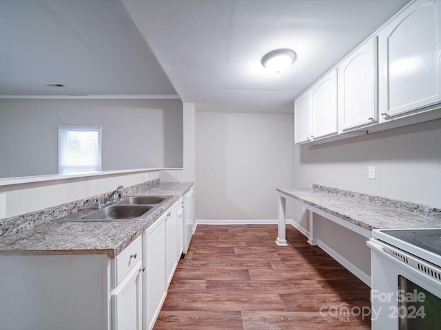 kitchen featuring hardwood / wood-style floors, white cabinets, sink, ornamental molding, and white range oven