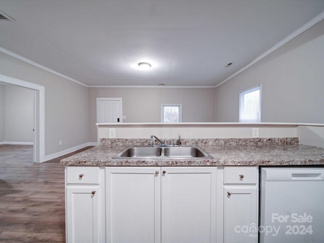 kitchen featuring hardwood / wood-style flooring, white cabinetry, sink, and ornamental molding