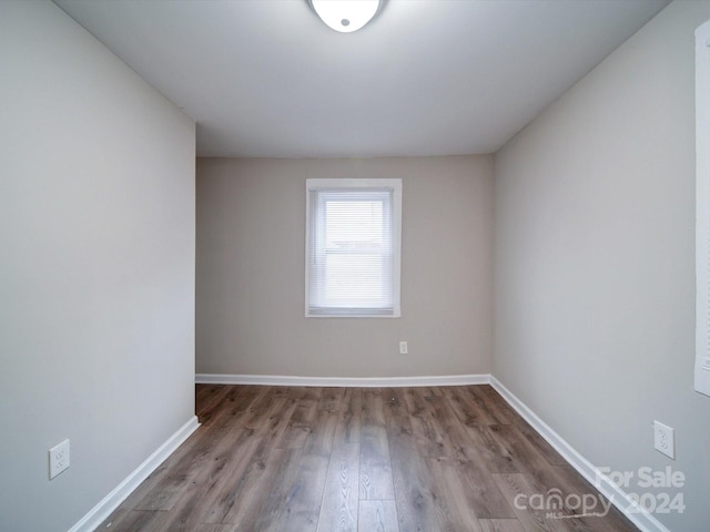 spare room featuring wood-type flooring