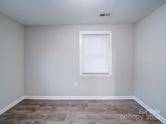 spare room with wood-type flooring