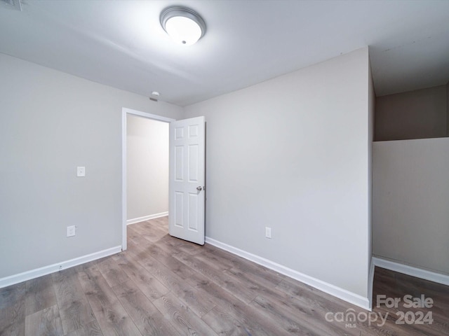 unfurnished room with hardwood / wood-style floors