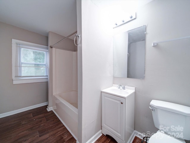 full bathroom with wood-type flooring, vanity, shower / bath combination, and toilet