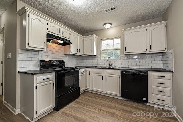 kitchen featuring black appliances, white cabinetry, backsplash, dark hardwood / wood-style flooring, and sink