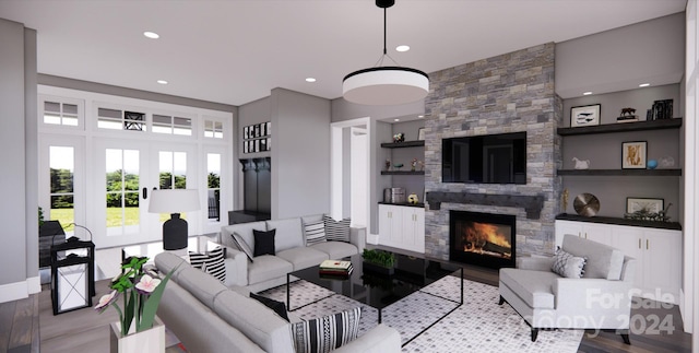 living room featuring french doors, a fireplace, light hardwood / wood-style flooring, and built in features