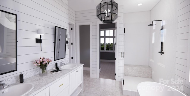 bathroom featuring shower with separate bathtub, an inviting chandelier, tile patterned flooring, wood walls, and vanity