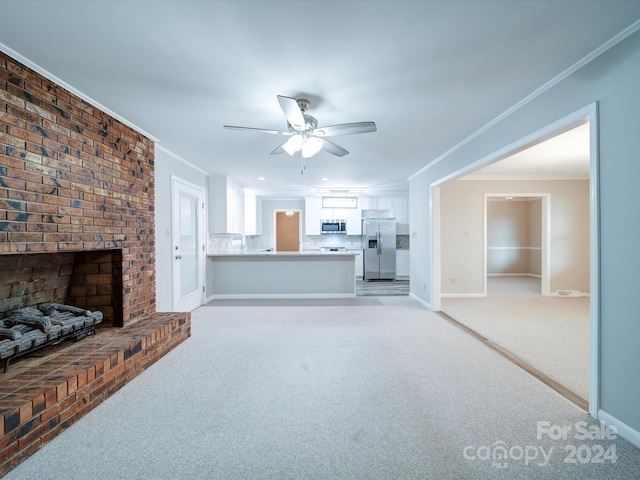 living room with ceiling fan, light colored carpet, a brick fireplace, and ornamental molding