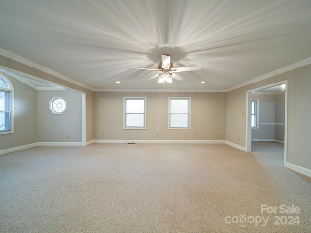 empty room featuring ceiling fan, light carpet, and ornamental molding