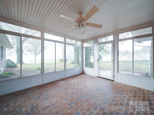 unfurnished sunroom with ceiling fan