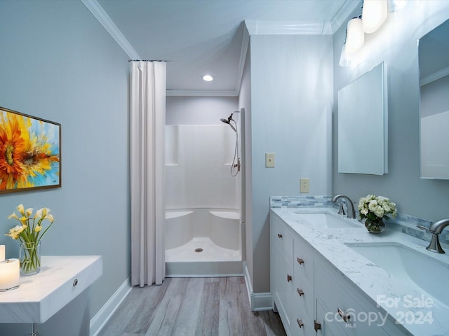 bathroom featuring curtained shower, wood-type flooring, crown molding, and vanity